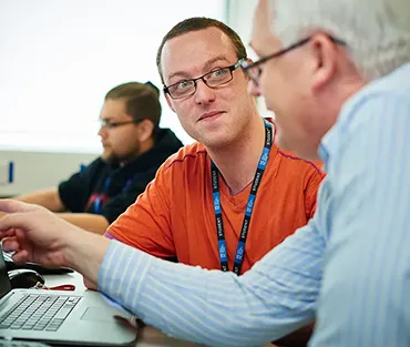 student and teacher at at computer